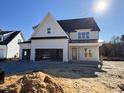 Two-story home featuring a three-car garage and a front porch, in mid-construction at 3520 Amelia Grace Dr # 30, Fuquay Varina, NC 27526
