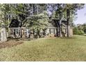 Inviting home with lush green lawn, mature tree, and classic brick facade, creating a welcoming atmosphere at 3540 Chelsea Dr, Rocky Mount, NC 27803