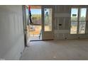 Entryway featuring a door with glass panels and a bright, unfinished interior at 142 Batten Hill Ln, Selma, NC 27576