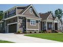 Beautiful home with shingle siding, stone accents, and a three car garage at 142 Batten Hill Ln, Selma, NC 27576