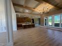 Open concept living space featuring a tray ceiling, large windows, and an eat-in kitchen at 142 Batten Hill Ln, Selma, NC 27576