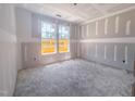 A bedroom is under construction, featuring drywall, unfinished floors, and large windows with natural light at 1901 Old Bramble Ln # 3, Fuquay Varina, NC 27526