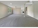 Spacious living room with neutral colors, carpet flooring, and a view into the next room at 6 Heatherford Ct, Durham, NC 27704