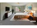 Comfortable main bedroom featuring a cozy rug, bedside lamps, and stylish decor at 6 Heatherford Ct, Durham, NC 27704