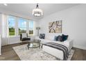 Bright living room featuring a large window, modern furnishings, and stylish decor at 424 La Maison Ave # 9, Wendell, NC 27591