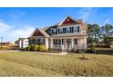 Charming two-story home featuring a welcoming front porch, and complemented by a beautifully landscaped yard at 46 Two Belles Ct, Angier, NC 27501