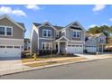 Street view of a two-story home with a two-car garage, set amongst similar houses at 504 Morning Glade St, Wake Forest, NC 27587
