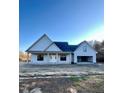Charming single-story home featuring a covered front porch and attached garage at 6270 River Rd, Fuquay Varina, NC 27526