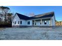 Spacious single-story home with a covered front porch and professional landscaping at 6270 River Rd, Fuquay Varina, NC 27526