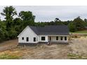Spacious single-story home with a covered front porch and professional landscaping at 6270 River Rd, Fuquay Varina, NC 27526