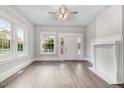 Bright living room with hardwood floors, fireplace, and large windows at 923 Belvedere St, Rocky Mount, NC 27803