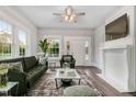 Bright living room with large windows, fireplace, stylish furniture, ceiling fan, and a neutral color palette throughout at 923 Belvedere St, Rocky Mount, NC 27803