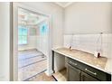 View of butler's pantry leading into dining room, complete with white subway tile and countertop space at 2625 Silver Gate Ct, Wake Forest, NC 27587