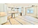 Bright kitchen featuring white cabinets, stainless steel appliances, and eat-in island with modern chandelier at 2625 Silver Gate Ct, Wake Forest, NC 27587