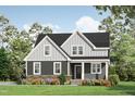 Two-story house with gray siding, white trim, stone accents, and a covered porch at 123 Wichita Way, Louisburg, NC 27549