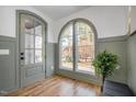Charming entryway featuring arched windows, stylish door, and beadboard paneling offers elegance at 1409 Sedgefield St, Durham, NC 27705