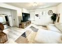 Inviting living room with a stylish rug, white couch, large TV, and neutral decor at 507 N Mack St, Creedmoor, NC 27522