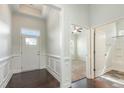 Bright entryway featuring dark hardwood floors and detailed trim work at 7533 Poplar Meadow Ln, Raleigh, NC 27616