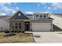 Attractive home with stone accents, a two-car garage, and a well-maintained front yard at 7533 Poplar Meadow Ln, Raleigh, NC 27616