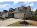 Inviting exterior of a home with stone accents and a two-car garage at 7533 Poplar Meadow Ln, Raleigh, NC 27616