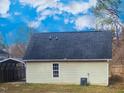 Rear view of house with AC unit and window at 806 Piper St, Durham, NC 27704