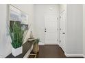 Inviting entryway featuring a console table with decor, leading to a white front door at 8204 Yaxley Hall Dr, Raleigh, NC 27616