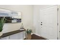 Close up of the entryway with artwork, decorations and a white front door at 8204 Yaxley Hall Dr, Raleigh, NC 27616