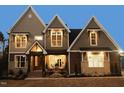 Two-story home with stone accents and a large front porch at 145 Wiggins Rd, Louisburg, NC 27549