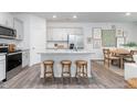 Bright kitchen with white cabinets, stainless steel appliances, granite countertops, and seating at the island at 1814 Hinesley Dr, Durham, NC 27703