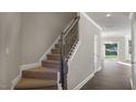 Elegant staircase with wood railing and plush carpet runner leads to the upper level at 1829 Hinesley Dr, Durham, NC 27703