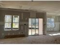 Spacious living room with sliding glass doors and large windows at 40 Dark Night Ln, Zebulon, NC 27597