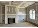 Living room with a fireplace and large windows at 40 Dark Night Ln, Zebulon, NC 27597