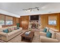 Cozy living room with wood paneled walls, fireplace, and plenty of seating at 503 Marshall Way, Durham, NC 27705