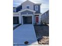 Two-story townhouse with gray siding, red front door, and an attached single-car garage in a new community at 1113 Mountain Crown St, Durham, NC 27703