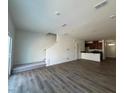 Open-concept space showcasing sleek flooring and staircase to upper level at 126 Parker Ln, Mebane, NC 27302