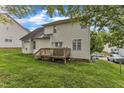 View of the home's rear exterior and wooden deck overlooking the lush, green backyard at 3236 Forest Mill Cir, Raleigh, NC 27616