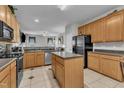 Functional kitchen with wooden cabinets, stainless steel appliances, and a central island at 3236 Forest Mill Cir, Raleigh, NC 27616