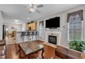 Cozy living room featuring a fireplace, dark hardwood floors, and an open layout to the kitchen at 3236 Forest Mill Cir, Raleigh, NC 27616
