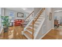 Bright staircase featuring hardwood floors and wooden handrails leads to the upper level of the house at 3236 Forest Mill Cir, Raleigh, NC 27616