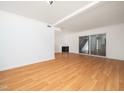 Spacious living room featuring hardwood floors and a cozy fireplace at 7124 Longstreet Dr # B, Raleigh, NC 27615