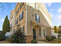 Attractive exterior featuring beige siding, black shutters, and well-maintained landscaping at 1120 Renewal Place # 108, Raleigh, NC 27603