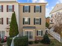Townhome with a well-kept lawn, black shutters, and a welcoming facade at 1120 Renewal Place # 108, Raleigh, NC 27603