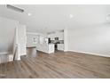 Bright, open-concept living space featuring wood floors and a modern kitchen with a center island at 1204 Holding Village Way, Wake Forest, NC 27587