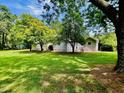 Spacious backyard featuring mature trees and plenty of green space, ideal for outdoor activities at 135 Weatherbend, Pittsboro, NC 27312