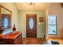 Elegant entryway with hardwood floors and a decorative mirror at 135 Weatherbend, Pittsboro, NC 27312