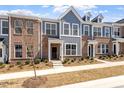New townhome featuring brick accents, gray siding, manicured landscaping and a welcoming front entrance at 281 Chesapeake Commons St # 95, Garner, NC 27529