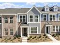 A modern townhome showcasing a stylish mix of brick and siding with a well-maintained front yard at 281 Chesapeake Commons St # 95, Garner, NC 27529