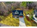 A birds-eye view showing the house, driveway, and surrounding yard and wooded property at 414 S Sb Harrison Ln, Henderson, NC 27537
