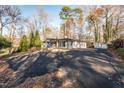 Ranch style home with a paved driveway and detached shed at 6512 Johnsdale Rd, Raleigh, NC 27615