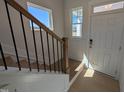 Bright foyer featuring hardwood floors, staircase, and natural light at 8 Steppe Way, Garner, NC 27529